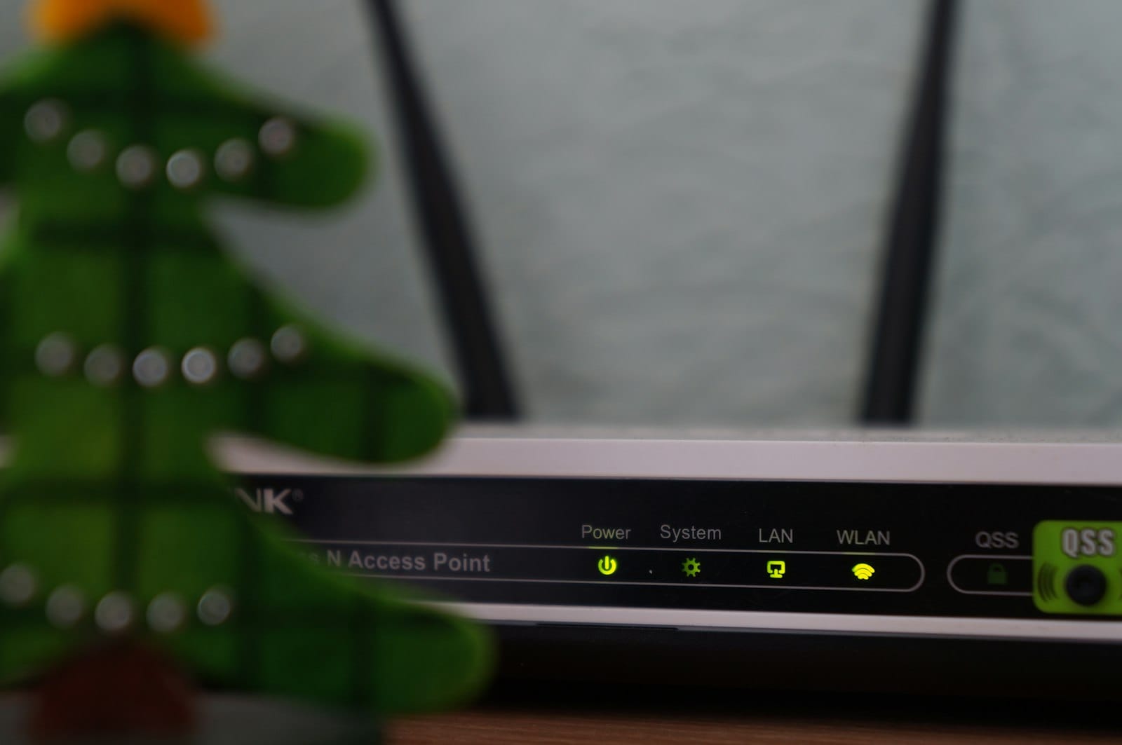 Close-up of a Wi-Fi router with its status lights on