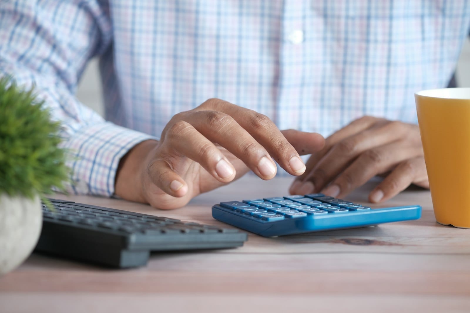 Person working out household costs on a calculator